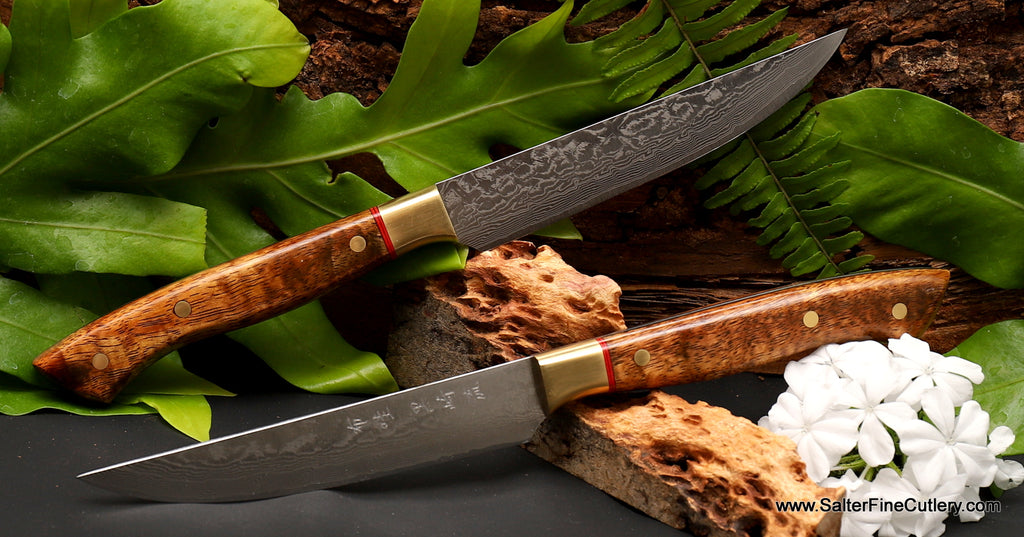 2-piece steak knife set featuring hand-forged R2 damascus blades and Hawaiian curly koa wood handles with brass and red accents from Salter Fine Cutlery of Hawaii