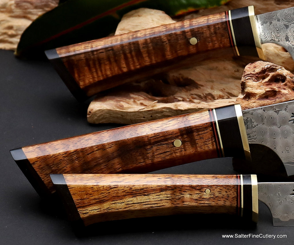Handle detail on 3-piece whirlpool damascus "Charybdis" collection chef knife set Curly koa wood with brass and ebony accents by Salter Fine Cutlery of Hawaii